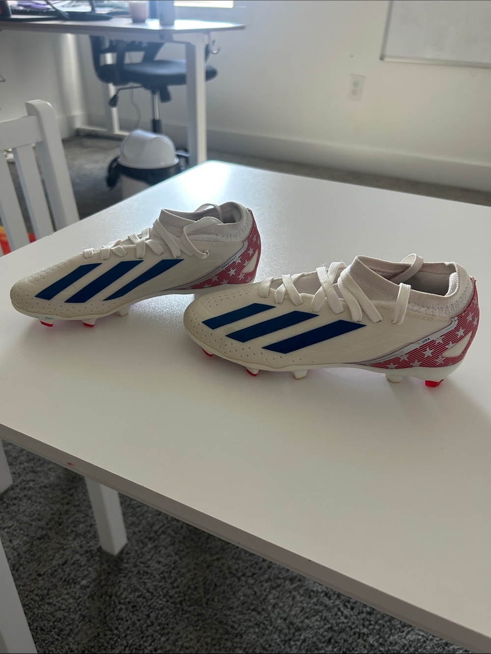 adidas Kids White Soccer Cleats with Blue Stripes and Red Star Heel Accents